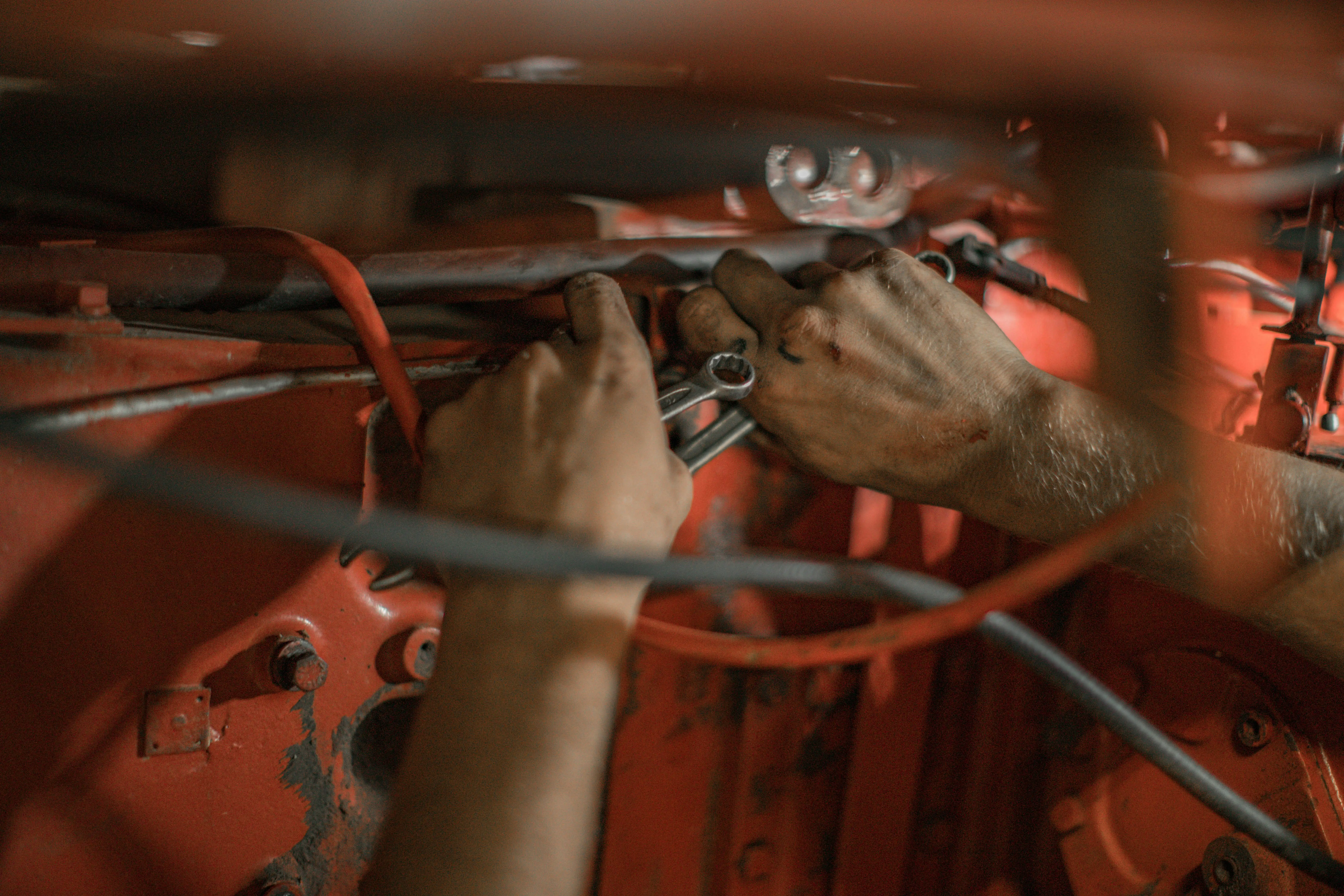 Mechaniker-Hände bei der Arbeit – sorgfältige Inspektion am Fahrzeug
